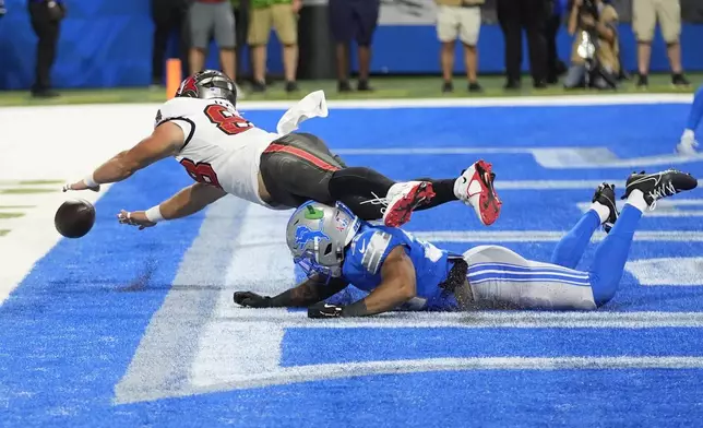 Tampa Bay Buccaneers tight end Cade Otton (88) is unable to catch the pass as Detroit Lions safety Brian Branch defends during the first half of an NFL football game, Sunday, Sept. 15, 2024, in Detroit. (AP Photo/Paul Sancya)