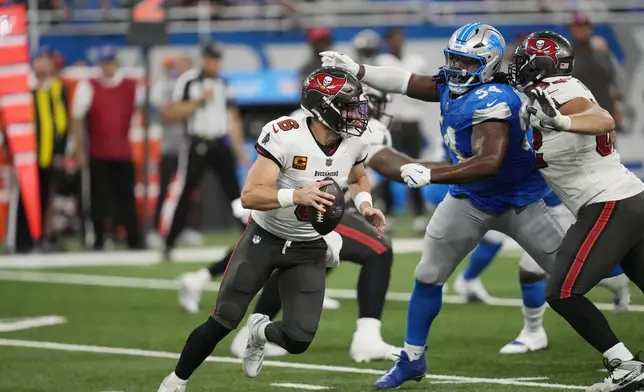 Tampa Bay Buccaneers quarterback Baker Mayfield (6) is pressured by Detroit Lions defensive tackle Alim McNeill (54) during the first half of an NFL football game, Sunday, Sept. 15, 2024, in Detroit. (AP Photo/Paul Sancya)