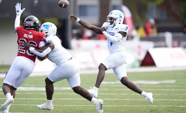 Buffalo quarterback C.J. Ogbonna throes as running back Jacqez Barksdale defends against Northern Illinois linebacker Jaden Dolphin during the first half of an NCAA college football game Saturday, Sept. 21, 2024, in DeKalb, Ill. (AP Photo/Charles Rex Arbogast)