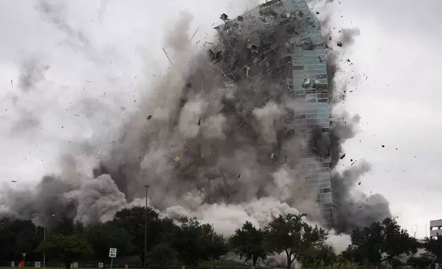 The Hertz Tower, that was heavily damaged after Hurricanes Laura and Delta in 2020, is imploded in Lake Charles, La., Saturday, Sept. 7, 2024. (AP Photo/Gerald Herbert)