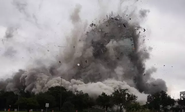 The Hertz Tower, that was heavily damaged after Hurricanes Laura and Delta in 2020, is imploded in Lake Charles, La., Saturday, Sept. 7, 2024. (AP Photo/Gerald Herbert)