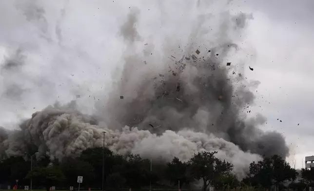 The Hertz Tower, that was heavily damaged after Hurricanes Laura and Delta in 2020, is imploded in Lake Charles, La., Saturday, Sept. 7, 2024. (AP Photo/Gerald Herbert)