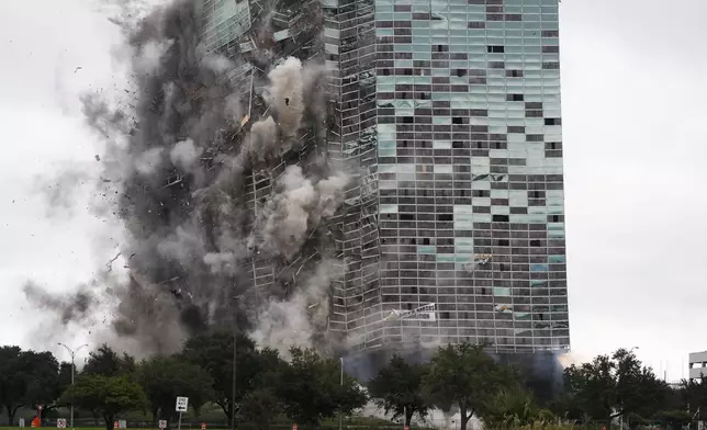 The Hertz Tower, that was heavily damaged after Hurricanes Laura and Delta in 2020, is imploded in Lake Charles, La., Saturday, Sept. 7, 2024. (AP Photo/Gerald Herbert)