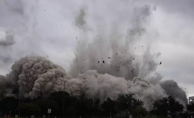 The Hertz Tower, that was heavily damaged after Hurricanes Laura and Delta in 2020, is imploded in Lake Charles, La., Saturday, Sept. 7, 2024. (AP Photo/Gerald Herbert)