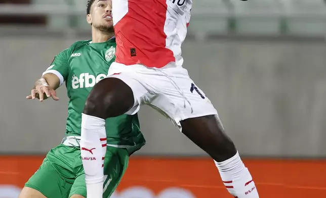 Ludogorets' Caio Vidal, leftt, vies for the ball with Slavia Praha's El Hadji Malick Diouf during their Europa League first match of the main phase, at Ludogorets Arena, Razgrad, Bulgaria, Wednesday, Sept. 25, 2024. (AP Photo/Tony Uzunov)