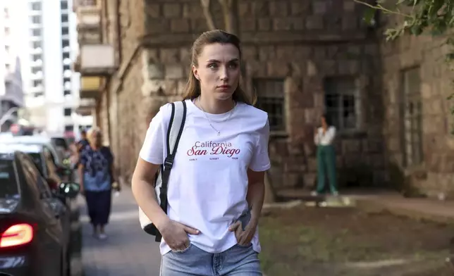 CORRECTS THE NAME OF SOURCE - Dziana Maiseyenka, 28, walks in a street in Yerevan, Armenia, Saturday, Sept. 7, 2024, after being denied entry to neighboring Georgia because an arrest warrant had been issued for her by authorities in Minsk. (Hayk Baghdasaryan/Photolure via AP)