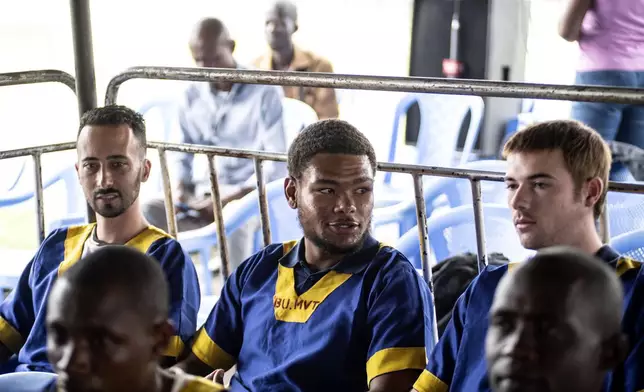 CORRECTS ID: Benjamin Reuben Zalman-Polun, left, Marcel Malanga and Tyler Thompson, all American citizens, attend a court verdict in Congo, Kinshasa, Friday Sept. 13, 2024, on charges of taking part in a coup attempt in May 2024. (AP Photo/Samy Ntumba Shambuyi)