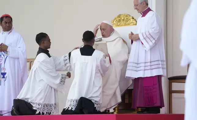 Pope Francis presides over a votive mass of the Blessed Virgin Mary Queen in Tasitolu, some 8 kilometers west of Dili, East Timor, Tuesday, Sept. 10, 2024. Pope Francis presides over a mass in a seaside park on the same field where St. John Paul II celebrated a historic liturgy during East Timor's fight for independence from Indonesian rule. (AP Photo/Gregorio Borgia)