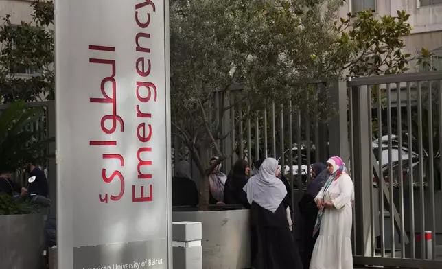 CORRECTS DAY TO TUESDAY WHEN INJURED Families of victims who were injured on Tuesday by their exploding handheld pagers, wait at the emergency entrance of the American University hospital, in Beirut, Lebanon, Wednesday, Sept. 18, 2024. (AP Photo/Hussein Malla)