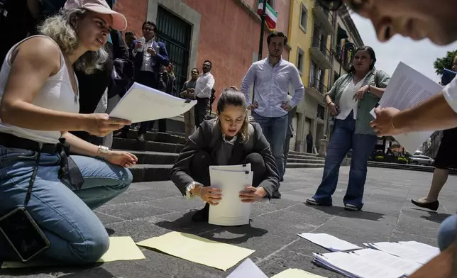 CORRECTS TO REMOVE THAT SENATORS ARE DISCUSSING JUDICIAL REFORM - Law students opposing judicial reform organize letters to senators outside an alternate headquarters for senators in Mexico City, Thursday, Sept. 5, 2024, one day after Mexico's lower house approved the legislation. (AP Photo/Felix Marquez)