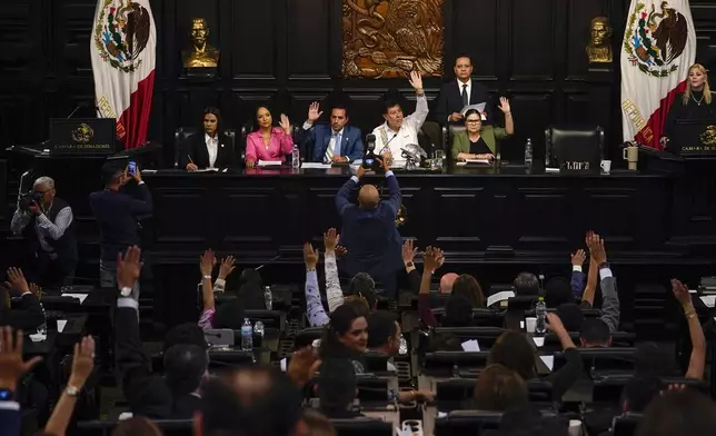 CORRECTS TO REMOVE THAT SENATORS ARE DISCUSSING JUDICIAL REFORM - Senators hold a session in alternate headquarters due to protesters opposing judicial reform blocking access to their regular chambers, in Mexico City, Thursday, Sept. 5, 2024, one day after Mexico's lower house approved the reform that would require all judges to stand for election . (AP Photo/Felix Marquez)