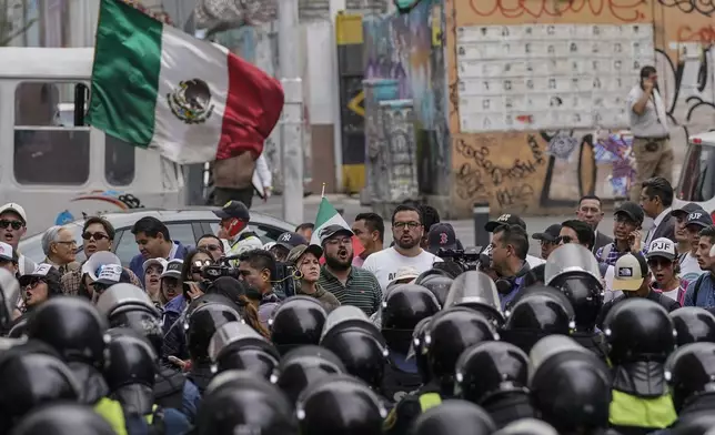 CORRECTS TO REMOVE THAT SENATORS ARE DISCUSSING JUDICIAL REFORM - Demonstrators opposing judicial reform that would require all judges to stand for election, protest outside an alternate headquarters for senators in Mexico City, Thursday, Sept. 5, 2024, one day after Mexico's lower house approved the legislation. (AP Photo/Felix Marquez)