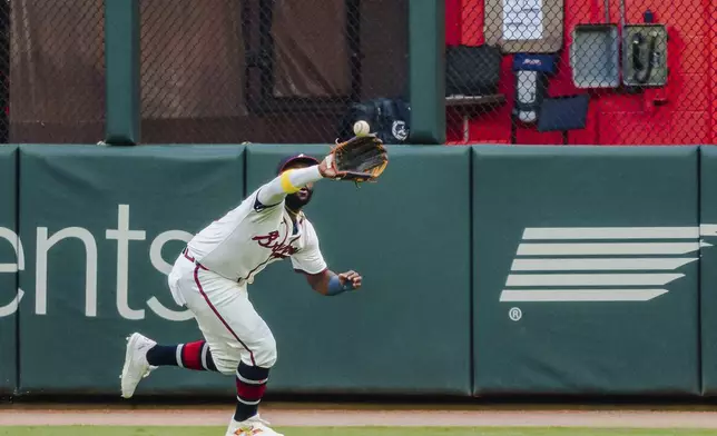 CORRECTS TO THURSDAY, SEPT. 5, NOT TUESDAY, SEPT. 3 - Atlanta Braves outfielder Michael Harris II catches a pop fly hit by Colorado Rockies' Brenton Doyle to right center field in the first inning of a baseball game, Thursday, Sept. 5, 2024, in Atlanta. (AP Photo/Jason Allen)