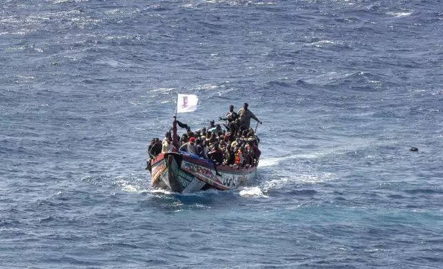 CORRECTS TO DELETE THE EXTRANEOUS WORD OF "UNAUTHORIZED" FROM THE SUBJECTS - FILE - Migrants crowd a wooden boat as they sail to the port in La Restinga on the Canary island of El Hierro, Spain, on Aug. 18, 2024. (AP Photo/Maria Ximena, File)