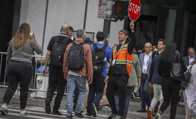 David Newlander escorts visitors to and from the Dreamforce conference in San Francisco, Tuesday, Sept. 17, 2024. (Brontë Wittpenn/San Francisco Chronicle via AP)