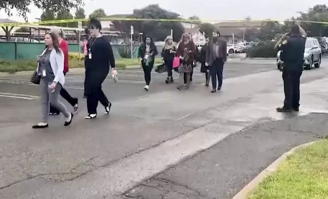 In this still image from video provided by KEYT, people walk past a police barricade following an explosion at the Santa Maria Courthouse in Santa Maria, Calif., Wednesday, Sept. 25, 2024. (KEYT via AP)