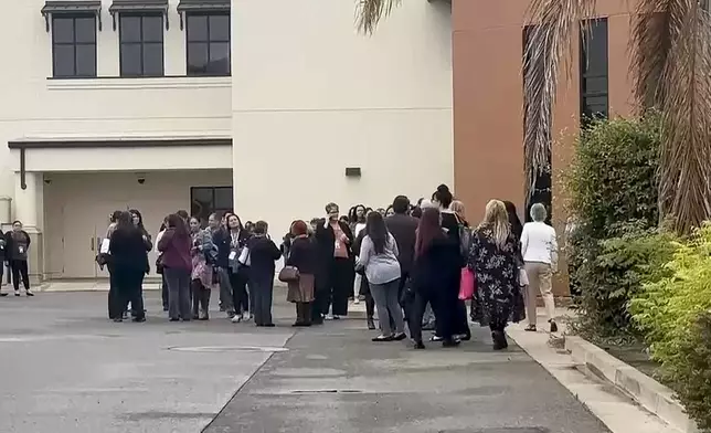 In this still image from video provided by KEYT, people gather following an explosion at the Santa Maria Courthouse in Santa Maria, Calif., Wednesday, Sept. 25, 2024. (KEYT via AP)