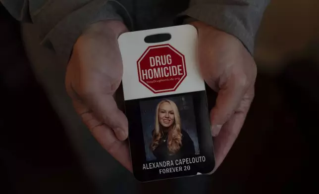 Matt Capelouto, whose daughter, Alexandra, died from a fentanyl overdose, holds an awareness card advocating for legal action against those responsible for drug-related deaths in Temecula, Calif., Tuesday, Sept. 17, 2024. (AP Photo/Jae C. Hong)