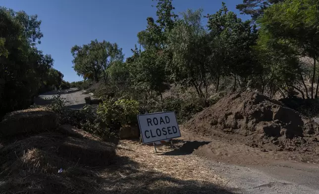 A road closure sign stands in a neighborhood affected by ongoing landslides in Rancho Palos Verdes, Calif., Tuesday, Sept. 3, 2024. (AP Photo/Jae C. Hong)