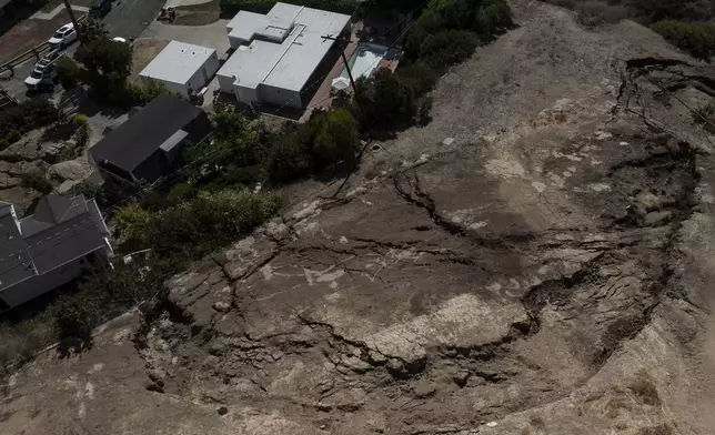 An aerial view shows a neighborhood affected by ongoing landslides in Rancho Palos Verdes, Calif., Tuesday, Sept. 3, 2024. (AP Photo/Jae C. Hong)