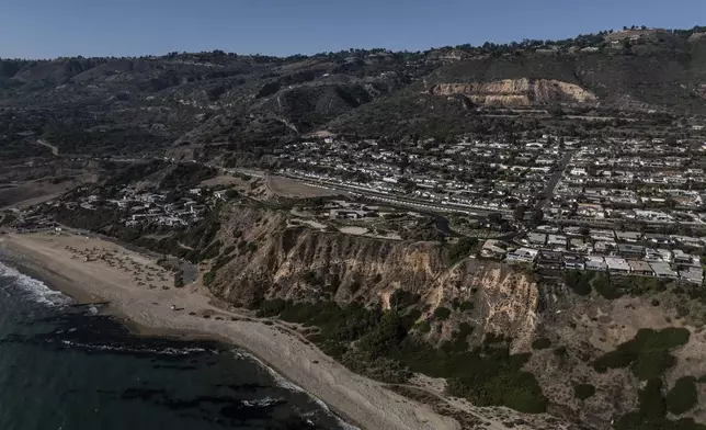 An aerial view shows a neighborhood affected by ongoing landslides in Rancho Palos Verdes, Calif., Tuesday, Sept. 3, 2024. (AP Photo/Jae C. Hong)