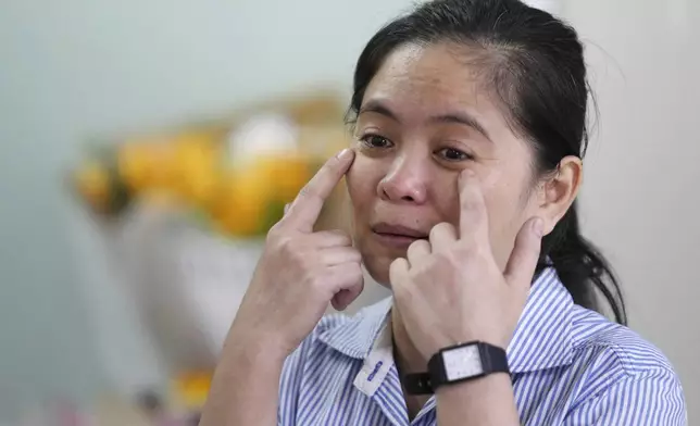 Chhim Sithar, president of the Labor Rights Supported Union of Khmer Employees of NagaWorld, gestures as she meets her supporters in a club at the outskirts of Phnom Penh Cambodia, Monday, Sept. 16, 2024, after the union leader was freed from prison on Monday after serving time for her part in a strike against the country's biggest casino. (AP Photo/Heng Sinith)