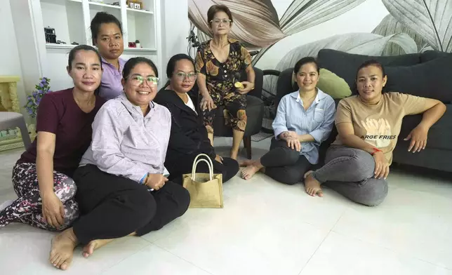 Chhim Sithar, second from right, president of the Labor Rights Supported Union of Khmer Employees of NagaWorld, sits near her mother, center, as she meets her staff members in her sister's home at the outskirts of Phnom Penh Cambodia, Monday, Sept. 16, 2024, after the prominent union leader freed from prison on Monday after serving time for her part in a strike against the country’s biggest casino. (AP Photo/Heng Sinith)