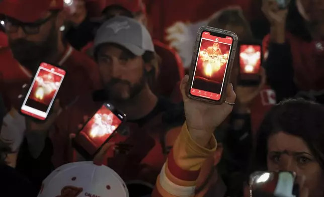 Fans attend a vigil for former Calgary Flames player Johnny Gaudreau and his brother Matthew in Calgary, Alberta., Wednesday, Sept. 4, 2024. (Jeff McIntosh/The Canadian Press via AP)