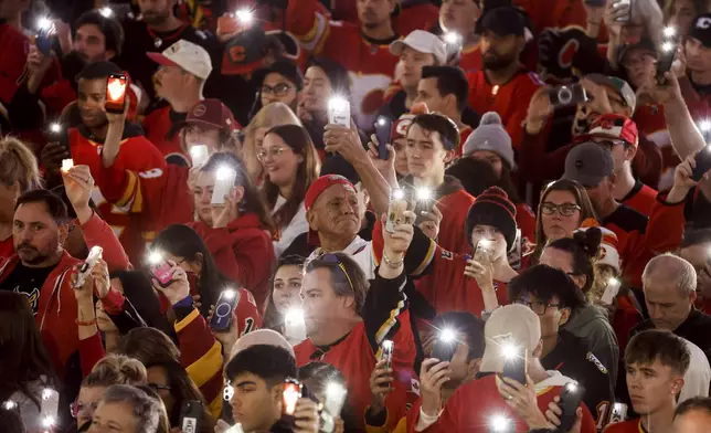 Fans attend a vigil for former Calgary Flames player Johnny Gaudreau and his brother Matthew in Calgary, Alberta, Wednesday, Sept. 4, 2024. (Jeff McIntosh/The Canadian Press via AP)