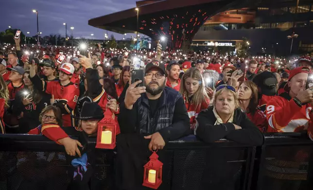 Fans attend a vigil for former Calgary Flames player Johnny Gaudreau and his brother Matthew in Calgary, Alberta, Wednesday, Sept. 4, 2024. (Jeff McIntosh/The Canadian Press via AP)