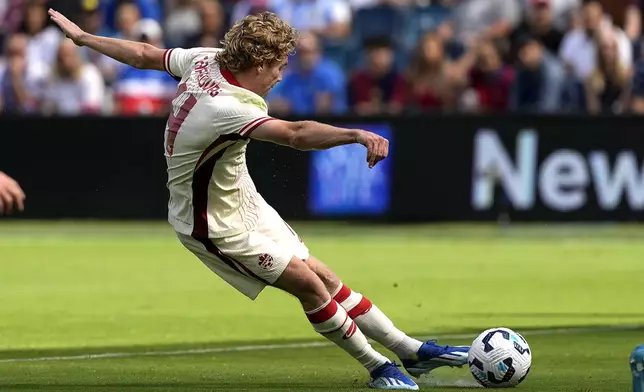 Canada forward Jacob Shaffelburg scores a goal during the first half of an international friendly soccer game against Canada, Saturday, Sept. 7, 2024, in Kansas City, Mo. (AP Photo/Charlie Riedel)