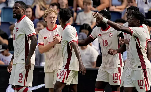 Canada forward Jacob Shaffelburg, second from left, celebrates with teammates after scoring a goal during the first half of an international friendly soccer game against United States, Saturday, Sept. 7, 2024, in Kansas City, Mo. (AP Photo/Charlie Riedel)