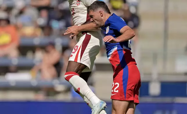 Canada defender Alphonso Davies beats United States defender Joe Scally (22) to the ball during the first half of an international friendly soccer game, Saturday, Sept. 7, 2024, in Kansas City, Mo. (AP Photo/Charlie Riedel)