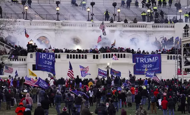 FILE - Violent protesters, loyal to President Donald Trump, storm the Capitol, Wednesday, Jan. 6, 2021, in Washington. (AP Photo/John Minchillo, File)