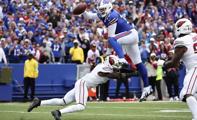 Buffalo Bills quarterback Josh Allen (17) leaps over Arizona Cardinals safety Budda Baker for a touchdown during the second half of an NFL football game Sunday, Sept. 8, 2024, in Orchard Park, N.Y. (AP Photo/Jeffrey T. Barnes)