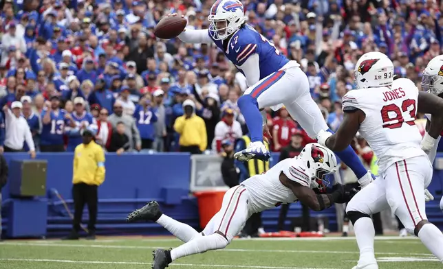 Buffalo Bills quarterback Josh Allen (17) leaps over Arizona Cardinals safety Budda Baker for a touchdown during the second half of an NFL football game Sunday, Sept. 8, 2024, in Orchard Park, N.Y. (AP Photo/Jeffrey T. Barnes)