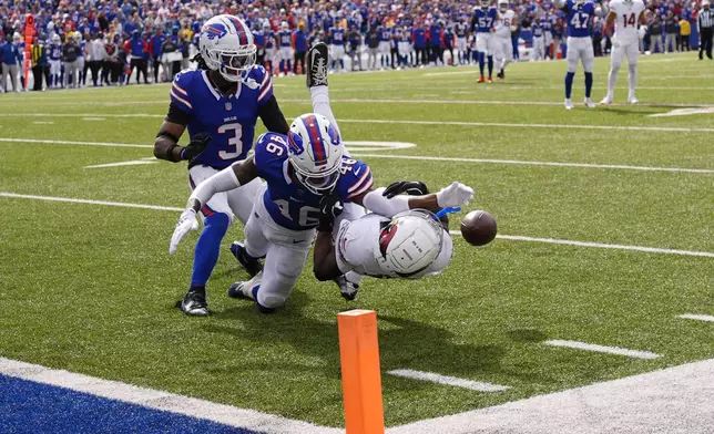 Arizona Cardinals wide receiver Greg Dortch, right, has a pass broken up by Buffalo Bills cornerback Ja'Marcus Ingram (46) as Bills safety Damar Hamlin (3) looks on during the second half of an NFL football game Sunday, Sept. 8, 2024, in Orchard Park, N.Y. The Bills won 34-28. (AP Photo/Matt Slocum)