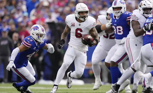 Arizona Cardinals running back James Conner (6) runs past Buffalo Bills linebacker Terrel Bernard (43) and Bills defensive tackle Austin Johnson, right, during the second half of an NFL football game Sunday, Sept. 8, 2024, in Orchard Park, N.Y. (AP Photo/Matt Slocum)