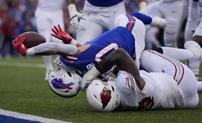 Buffalo Bills wide receiver Khalil Shakir, top, dives for the endzone for a touchdown as Arizona Cardinals defensive tackle Justin Jones is unable to make the tackle during the second half of an NFL football game Sunday, Sept. 8, 2024, in Orchard Park, N.Y. (AP Photo/Matt Slocum)