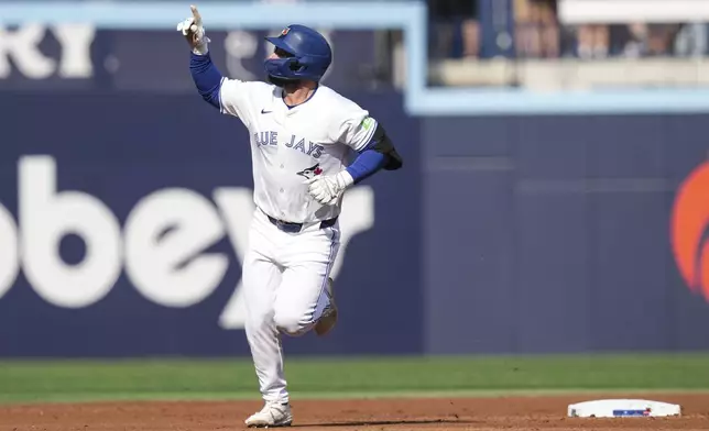 Toronto Blue Jays' Davis Schneider rounds the bases after hitting a home run off St. Louis Cardinals pitcher Kyle Gibson during third inning interleague MLB baseball action in Toronto, Saturday Sept. 14, 2024. (Chris Young/The Canadian Press via AP)