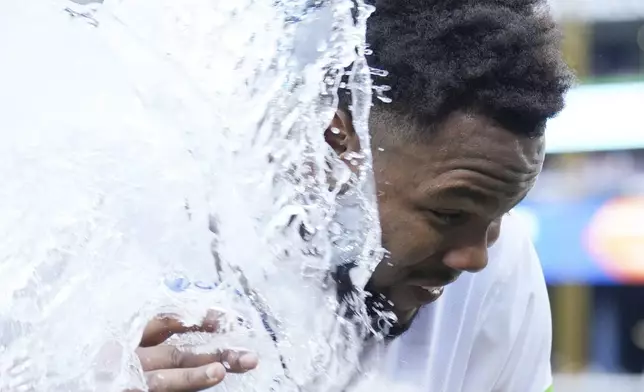 Toronto Blue Jays' Vladimir Guerrero Jr. is doused after defeating the St. Louis Cardinals in interleague MLB baseball action in Toronto, Saturday, September 14, 2024. (Chris Young/The Canadian Press via AP)