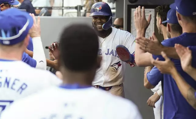 Toronto Blue Jays' Vladimir Guerrero Jr. celebrates in the dugout after scoring a run during seventh inning interleague MLB baseball action against the St. Louis Cardinals in Toronto, Saturday, September 14, 2024. (Chris Young/The Canadian Press via AP)