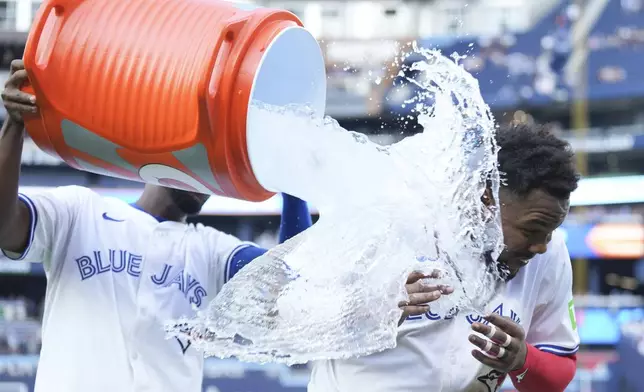 Toronto Blue Jays' Vladimir Guerrero Jr. is doused after defeating the St. Louis Cardinals in interleague MLB baseball action in Toronto, Saturday, September 14, 2024. (Chris Young/The Canadian Press via AP)