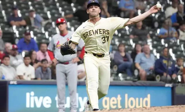 Milwaukee Brewers pitcher DL Hall throws to first for the out on a bunt by St. Louis Cardinals' Michael Siani during the sixth inning of a baseball game Wednesday, Sept. 4, 2024, in Milwaukee. (AP Photo/Kayla Wolf)