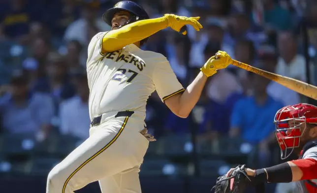 Milwaukee Brewers Willy Adames (27) watches his three-run home run during the first inning of a baseball game against the St. Louis Cardinals Monday, Sept. 2, 2024, in Milwaukee. (AP Photo/Jeffrey Phelps)