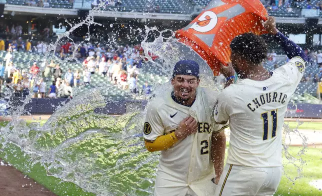 Milwaukee Brewers' Jackson Chourio (11) douses Willy Adames, left, after a baseball game against the St. Louis Cardinals, Monday, Sept. 2, 2024, in Milwaukee. (AP Photo/Jeffrey Phelps)