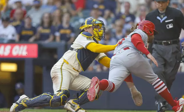 St. Louis Cardinals' Brendan Donovan (33) is tagged out by Milwaukee Brewers catcher William Contreras during the fourth inning of a baseball game, Monday, Sept. 2, 2024, in Milwaukee. (AP Photo/Jeffrey Phelps)