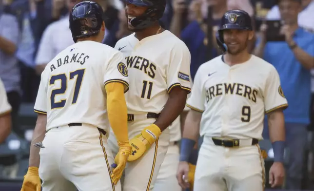 Milwaukee Brewers Willy Adames (27) reacts with Jackson Chourio(11) after his three-run home run during the first inning of a baseball game against the St. Louis Cardinals Monday, Sept. 2, 2024, in Milwaukee. (AP Photo/Jeffrey Phelps)