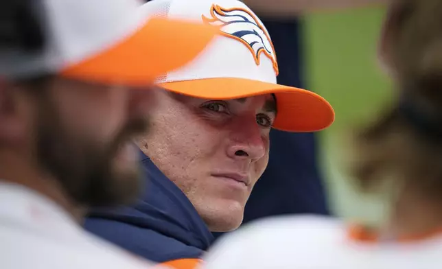 Denver Broncos quarterback Bo Nix sits on the team bench during the second half of a preseason NFL football game against the Arizona Cardinals, Sunday, Aug. 25, 2024, in Denver. (AP Photo/Jack Dempsey)