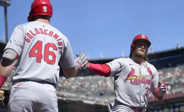 St. Louis Cardinals' Brendan Donovan, right, is congratulated by Paul Goldschmidt (46) after hitting a solo home run during the third inning of a baseball game against the San Francisco Giants, Sunday, Sept. 29, 2024, in San Francisco. (AP Photo/Tony Avelar)